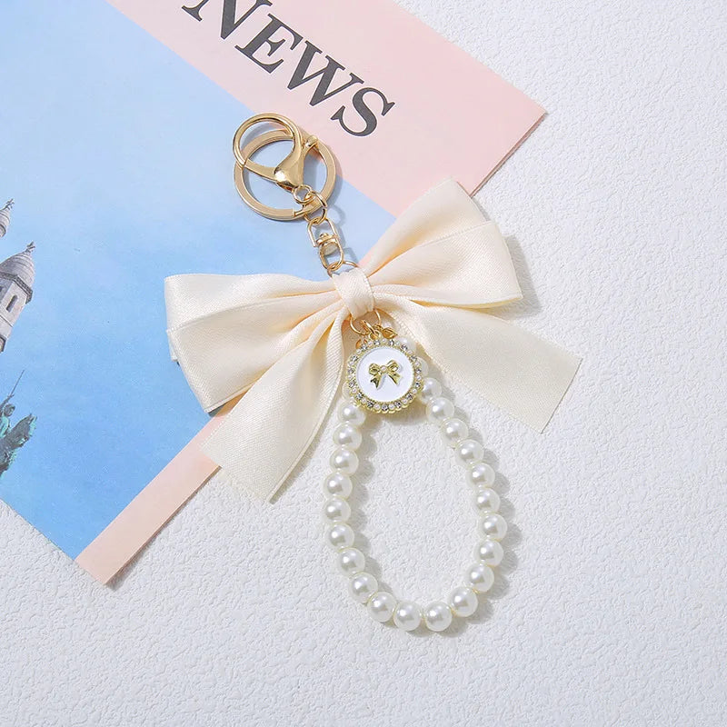 Niedlicher Taschenanhänger, Accessoire in Gold mit Schleifen - Anhänger